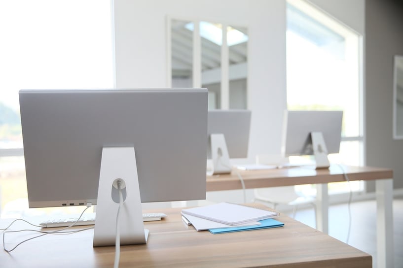 Desktop computers set on tables in classroom.jpeg